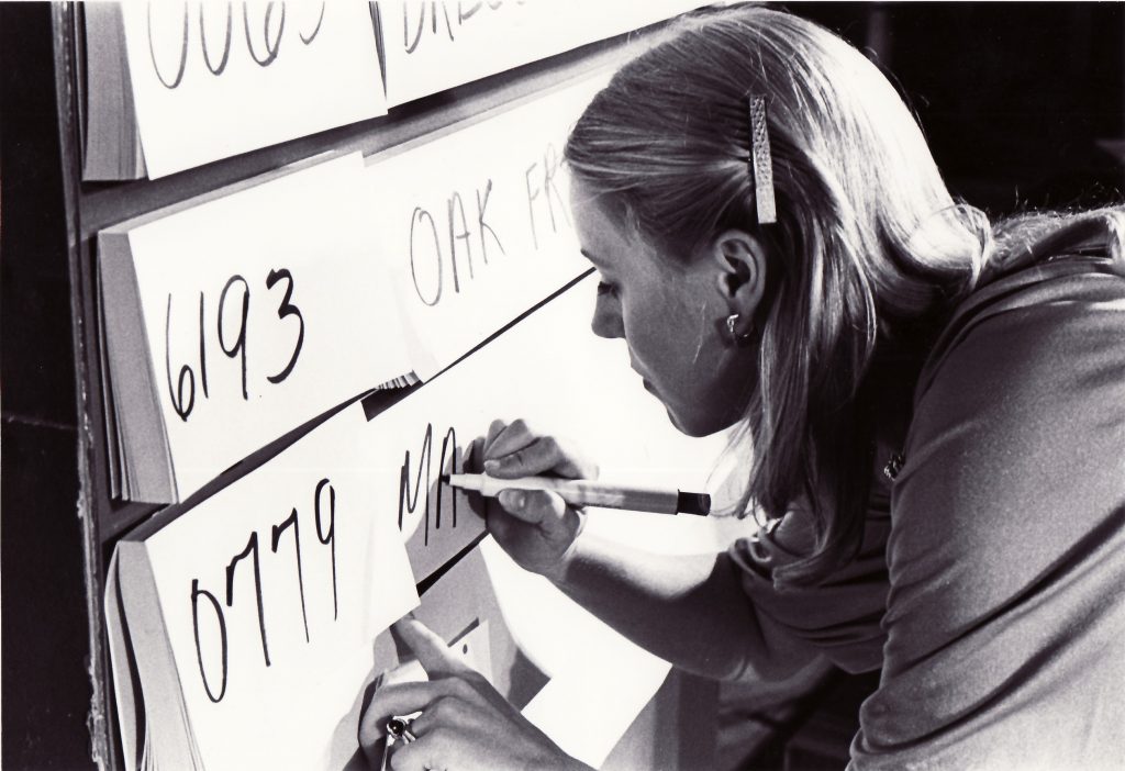A woman updating auction board