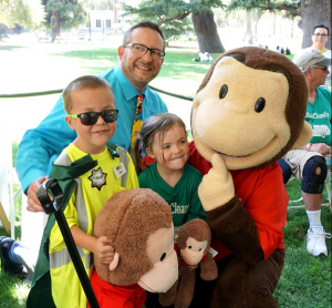 Ethan, with KVIE's GM David Lowe and Curious George