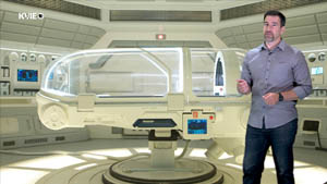A man stands in front of a futuristic surgical pod from Star Trek