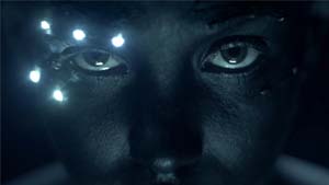 A face in dark light, illuminated by five LED lights around the subject's right eye