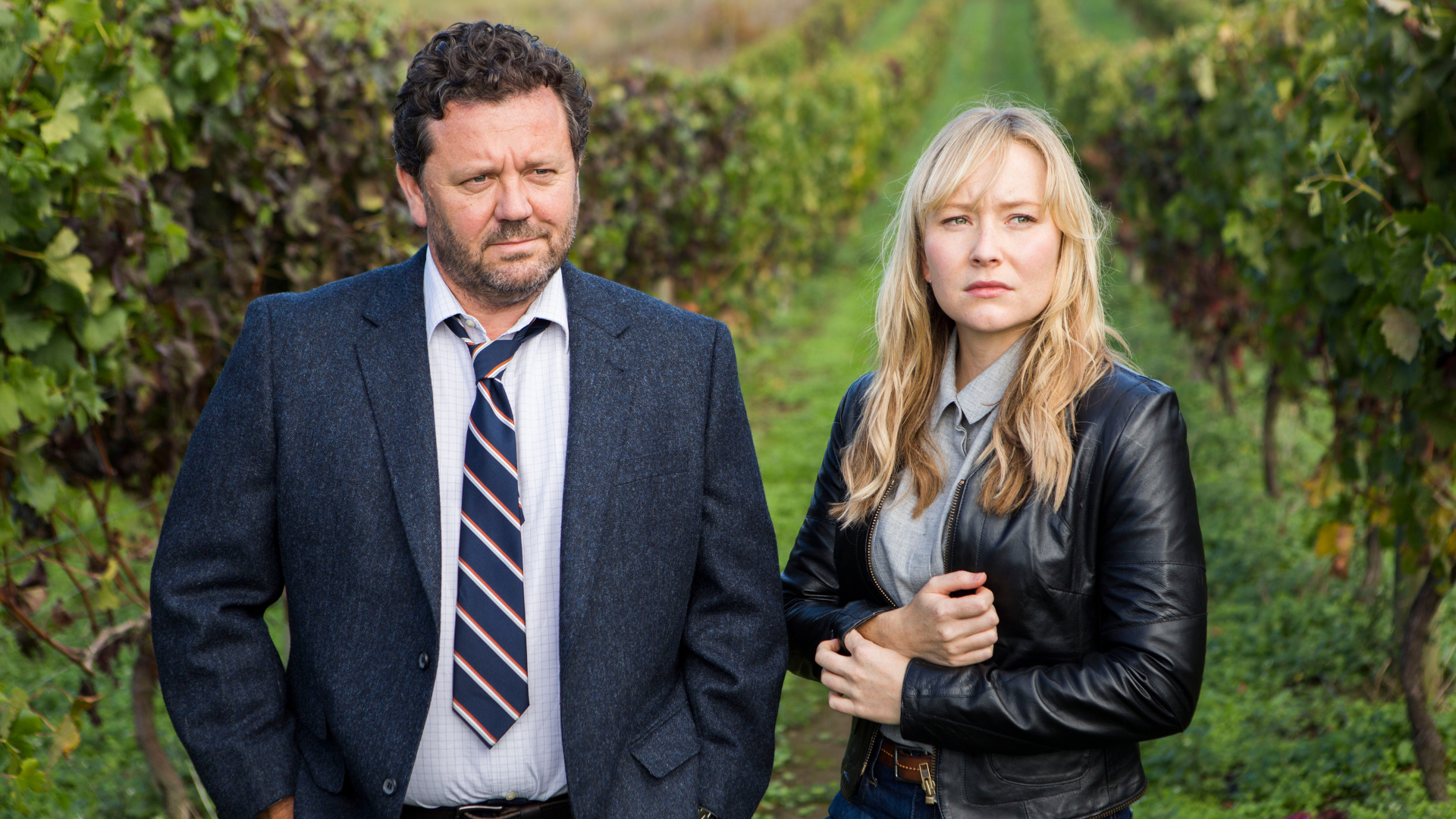 From left, Mike Shepherd and Kristin Sims standing in a vineyard. 