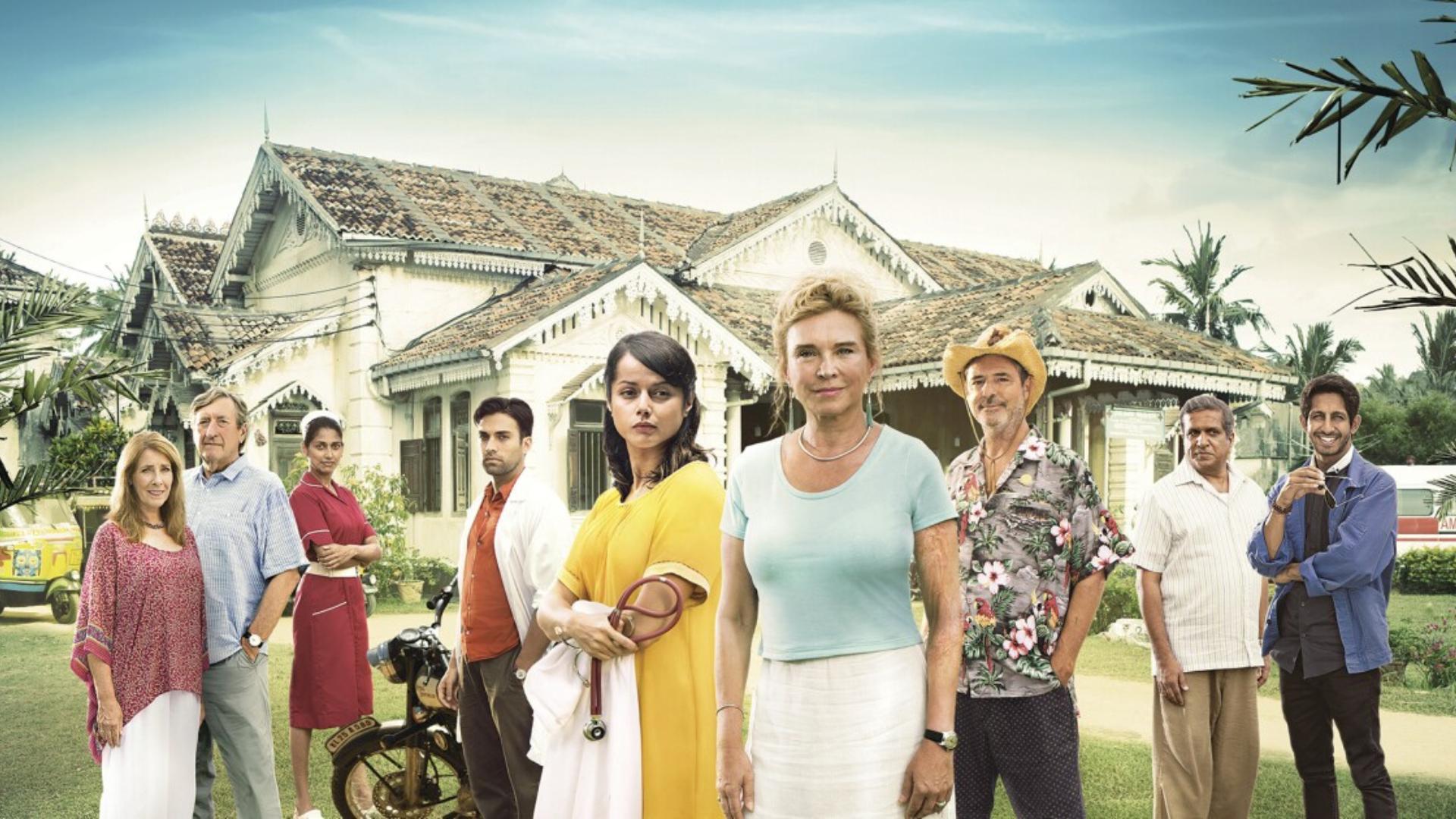 The characters, including Dr. Ruby Walker, Dr. Lydia Fonseca, Dr. Gabriel Varma, and Greg McConnell, standing in front of a rustic country hospital. 