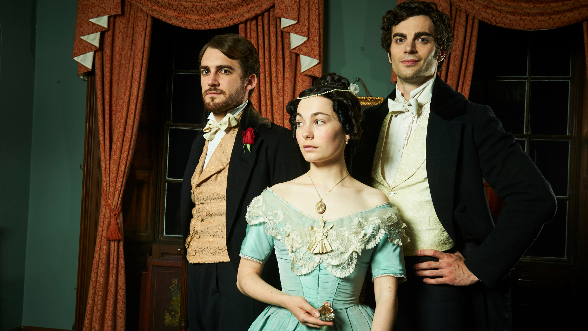 From left, Franklin, Rachel, and Godfrey. Rachel is holding a jewel in her hand. 