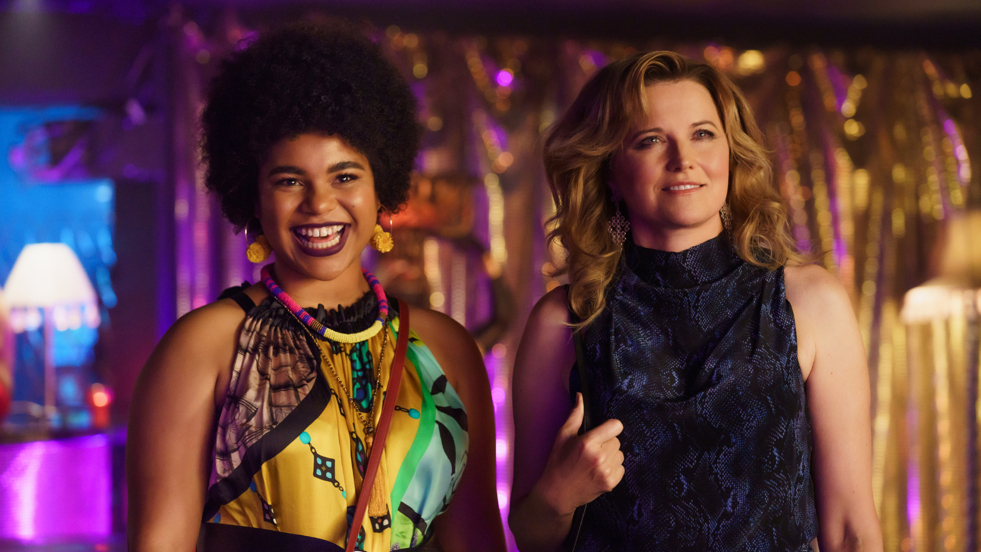Madison, left, and Alexa, right, stand side-by-side in a nightclub. 